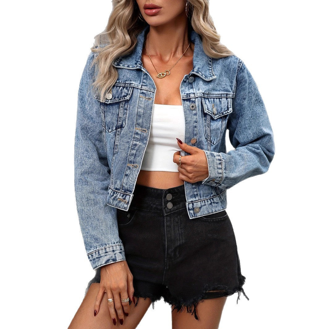 Model wearing an autumn denim coat in light blue, styled with a white crop top and black shorts.