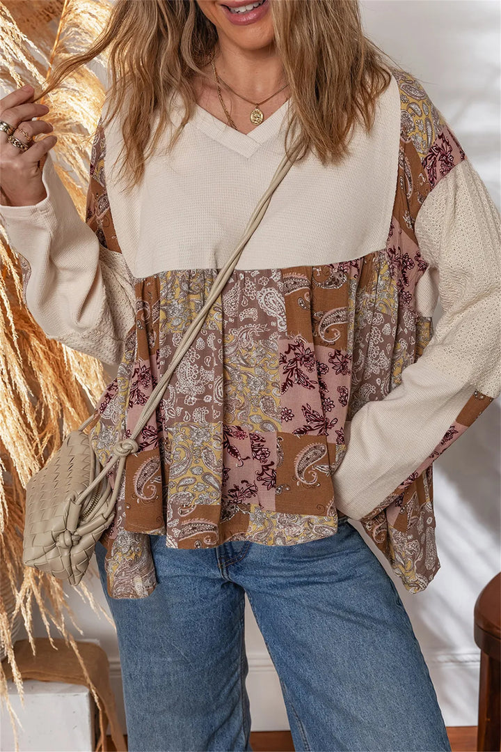 beige paisley ethnic print top worn by a model with a casual outfit and crossbody bag, showcasing a trendy layered design.